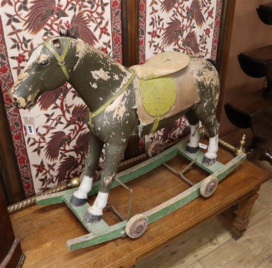 A painted wooden pull-along rocking horse L.90cm